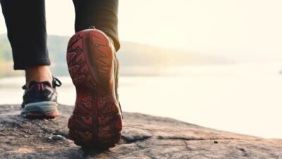 Person walking outdoors for exercise on a sunny day