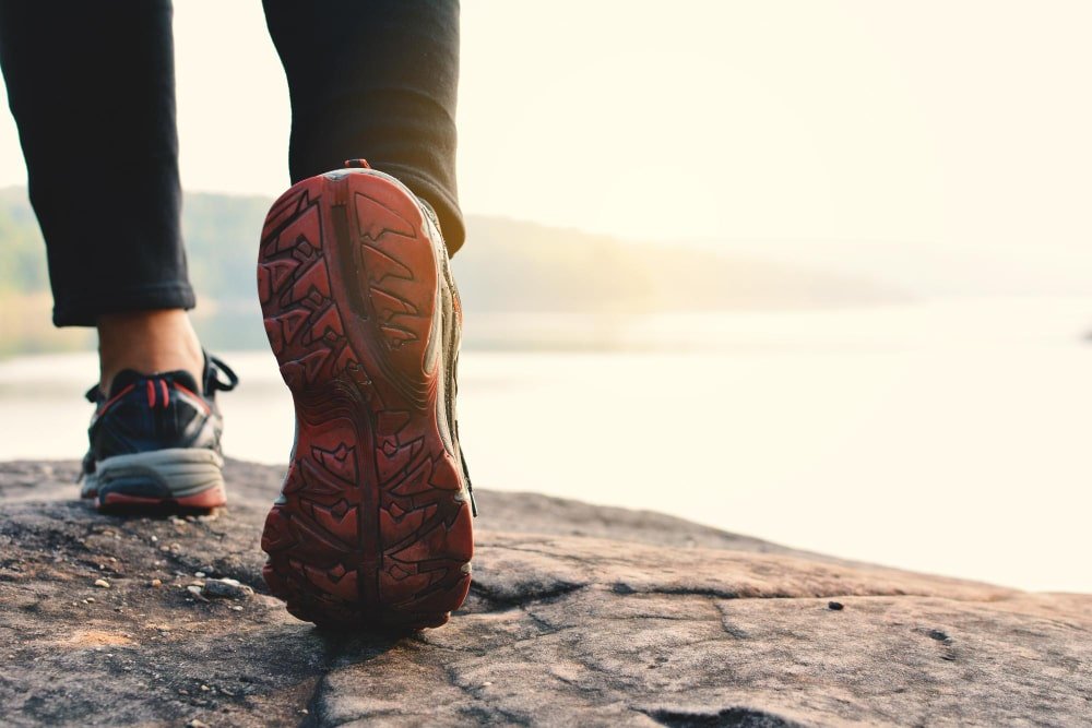 Person walking outdoors for exercise on a sunny day